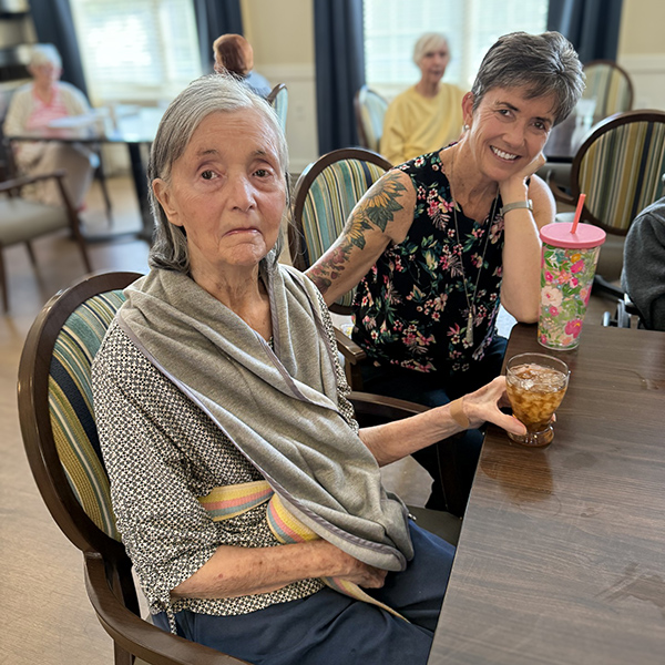 A loved one and senior woman enjoy a relaxed moment together.